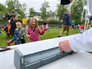 Girl smiling with fishing pole.